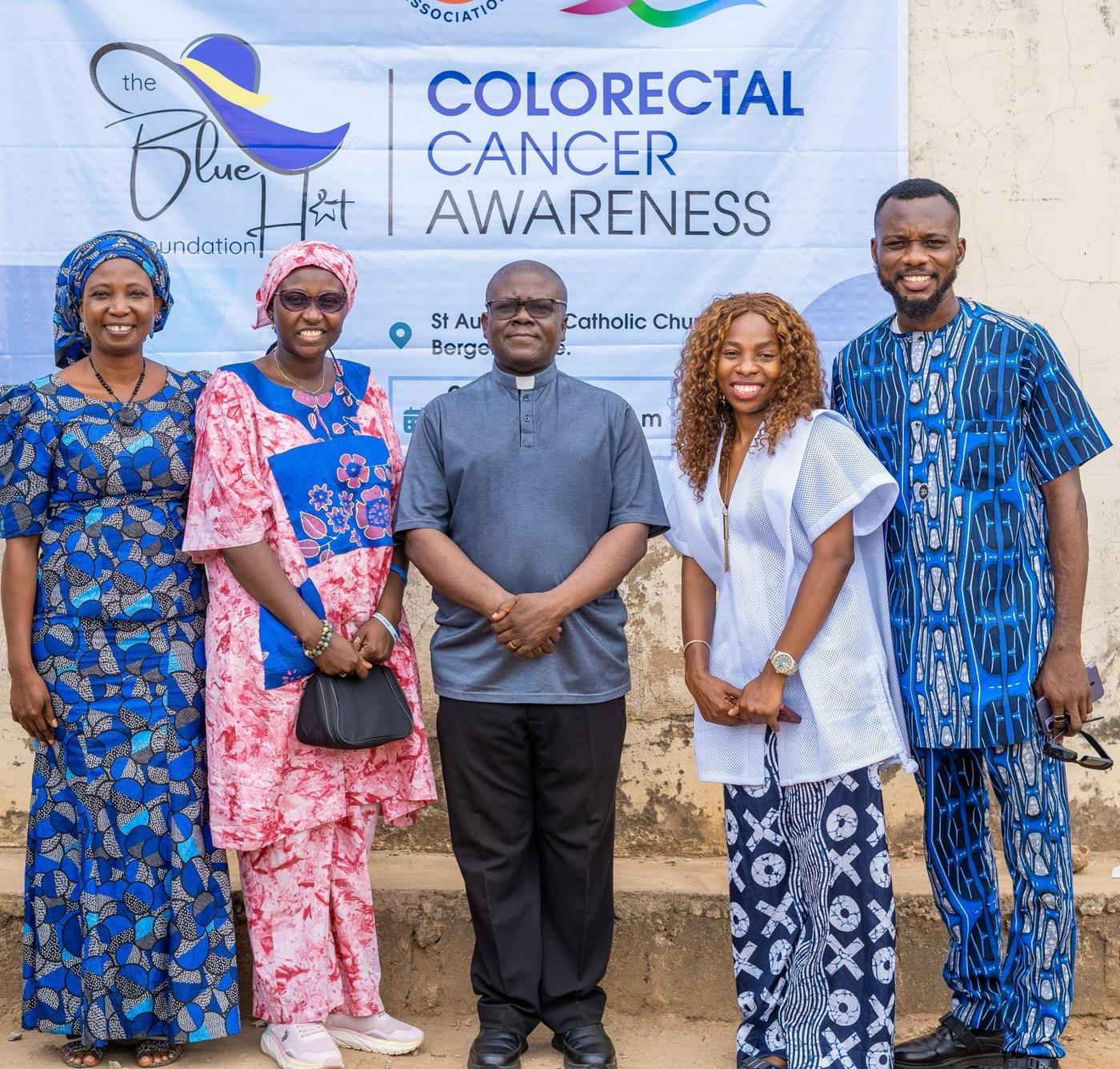 MHFCO team with clergy and partners in front of the awareness banner